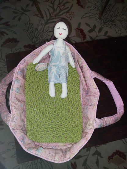 Doll in bed basket