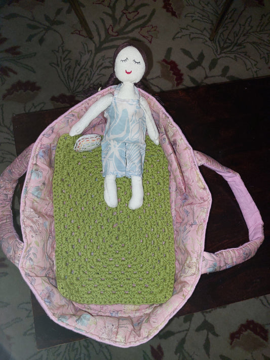 Doll in bed basket